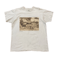 White t-shirt with a vintage-style graphic of ships on water in between waves. A small The Stokes text is written underneath the image on the lower left. 